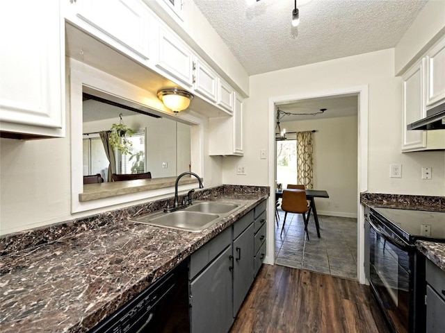 100 Lido Cir Unit A1, Lakeway, TX 78734 - kitchen with black appliances, dark countertops, dark wood-style flooring, white cabinets, and a textured ceiling