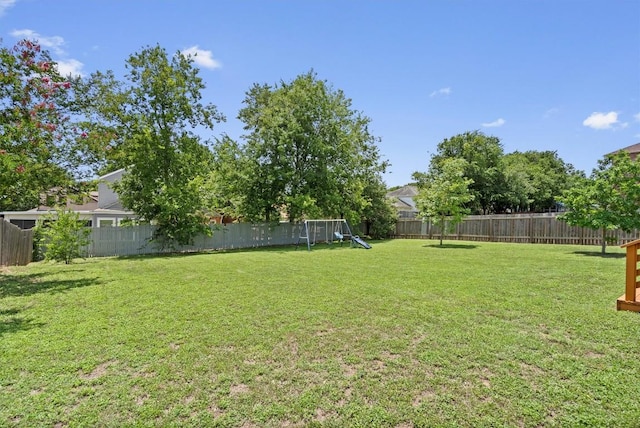 509 Red Tailed Hawk Dr, Pflugerville, TX 78660 - fenced backyard with a playground