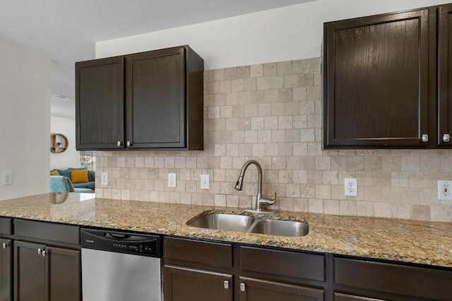 509 Red Tailed Hawk Dr, Pflugerville, TX 78660 - kitchen with stainless steel dishwasher, dark brown cabinets, and decorative backsplash