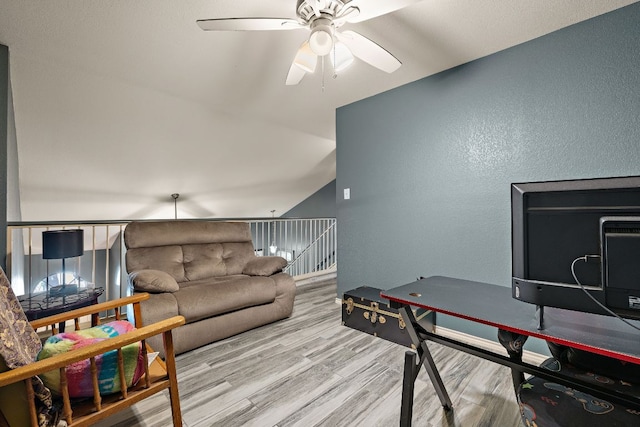 3010 Adam Cv, Round Rock, TX 78681 - living area with ceiling fan, wood finished floors, a textured wall, and vaulted ceiling