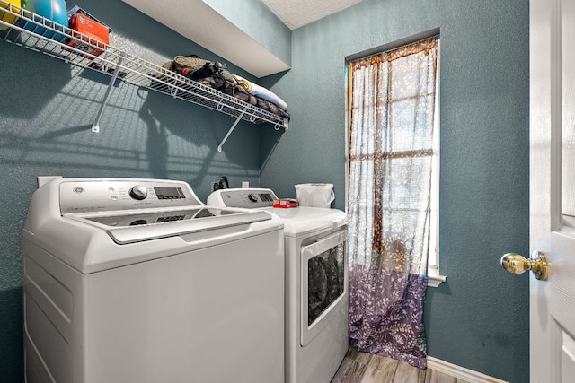 3010 Adam Cv, Round Rock, TX 78681 - laundry area featuring independent washer and dryer, wood finished floors, and a textured wall