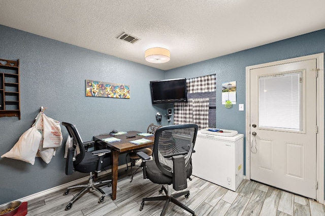 3010 Adam Cv, Round Rock, TX 78681 - office featuring a textured wall, wood finished floors, and a textured ceiling