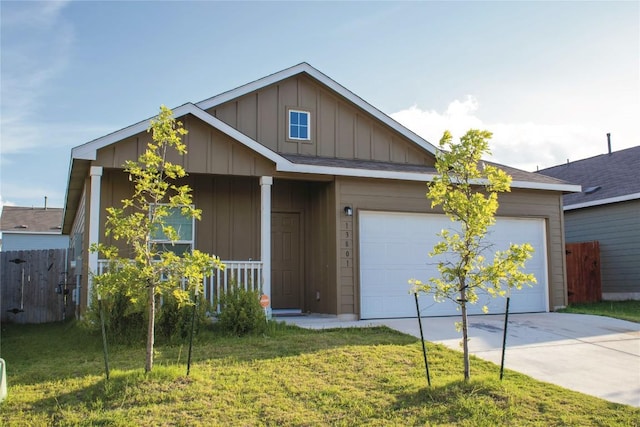 13801 Tordillo Dr, Elgin, TX 78621 - view of front of property with board and batten siding, concrete driveway, an attached garage, and a porch