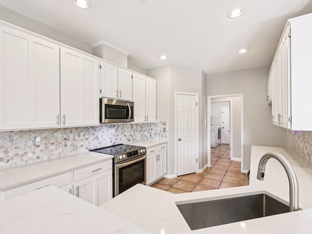 152 Acapulco Dr, Lakeway, TX 78734 - kitchen featuring stainless steel appliances, white cabinets, backsplash, recessed lighting, and light tile patterned floors