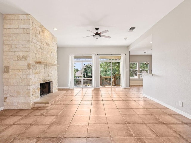 152 Acapulco Dr, Lakeway, TX 78734 - unfurnished living room with ceiling fan, a stone fireplace, and light tile patterned floors