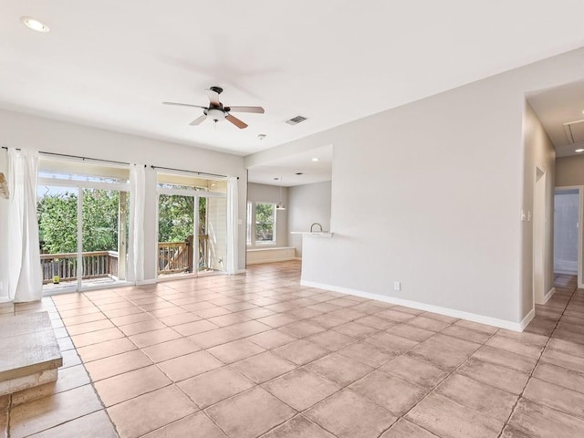 152 Acapulco Dr, Lakeway, TX 78734 - unfurnished living room with ceiling fan, light tile patterned floors, and attic access