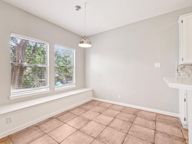 152 Acapulco Dr, Lakeway, TX 78734 - unfurnished dining area with light tile patterned floors and baseboards