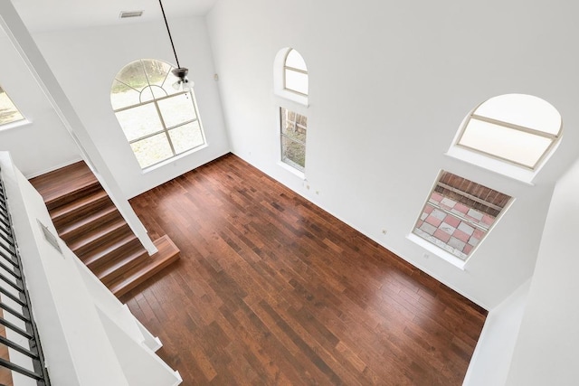 1505 Thibodeaux Dr, Round Rock, TX 78664 - foyer entrance with high vaulted ceiling, wood finished floors, and stairway