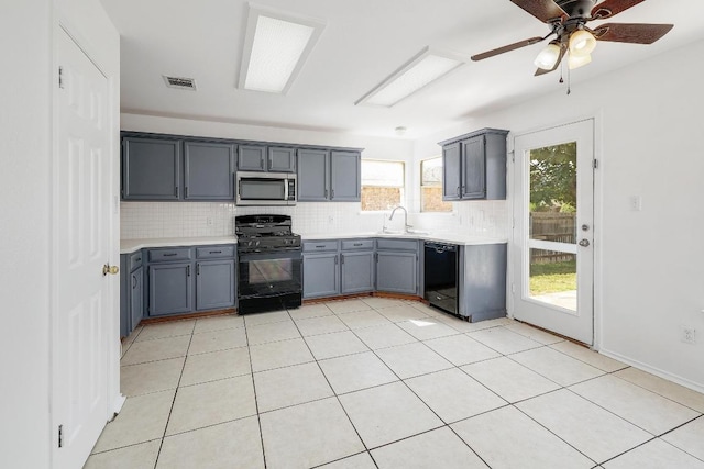 1505 Thibodeaux Dr, Round Rock, TX 78664 - kitchen featuring black appliances, gray cabinets, backsplash, and light countertops