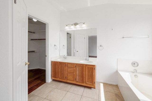 1505 Thibodeaux Dr, Round Rock, TX 78664 - full bath with double vanity, a garden tub, tile patterned floors, and a walk in closet