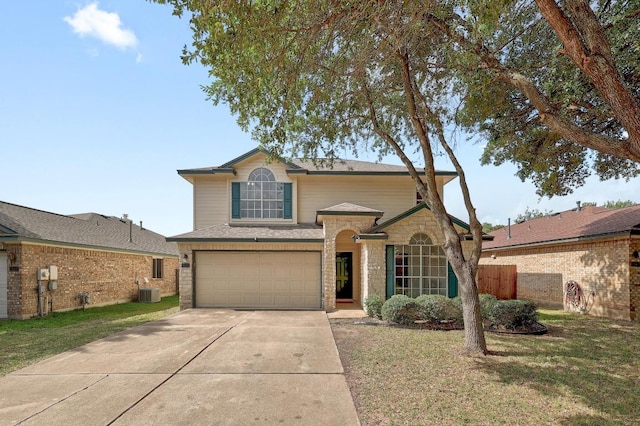 1505 Thibodeaux Dr, Round Rock, TX 78664 - traditional home with an attached garage, concrete driveway, a front lawn, and stone siding
