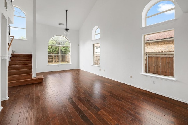 1505 Thibodeaux Dr, Round Rock, TX 78664 - unfurnished living room with high vaulted ceiling, hardwood / wood-style flooring, and stairs
