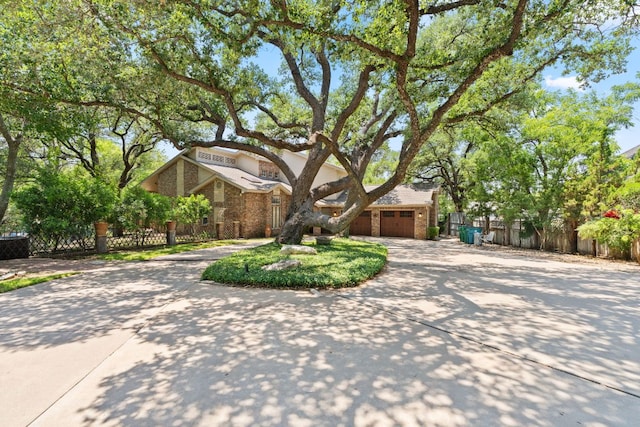 1005 Terry Ln, Kingsland, TX 78639 - view of front of house with curved driveway, brick siding, and a garage