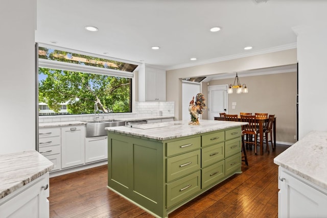 1005 Terry Ln, Kingsland, TX 78639 - kitchen featuring green cabinets, white cabinetry, tasteful backsplash, a chandelier, and a center island