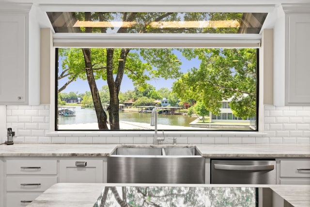 1005 Terry Ln, Kingsland, TX 78639 - kitchen featuring a water view, decorative backsplash, and white cabinetry