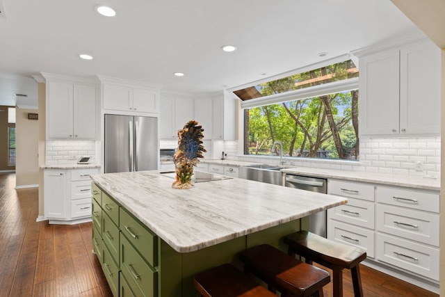 1005 Terry Ln, Kingsland, TX 78639 - kitchen featuring stainless steel appliances, green cabinetry, white cabinets, decorative backsplash, and recessed lighting