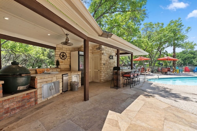 1005 Terry Ln, Kingsland, TX 78639 - view of patio featuring an outdoor kitchen and outdoor dining space