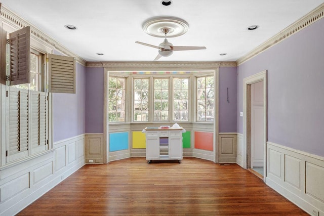 3201 W Ave, Austin, TX 78705 - spare room featuring ceiling fan, wainscoting, ornamental molding, wood finished floors, and a decorative wall