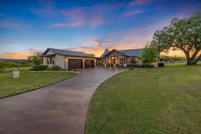 196 Westgate Loop, Horseshoe Bay, TX 78657 - view of front of house featuring an attached garage, asphalt driveway, a chimney, and a metal roof