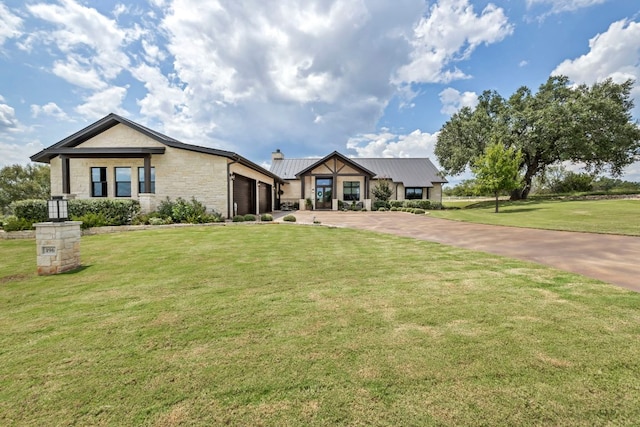 196 Westgate Loop, Horseshoe Bay, TX 78657 - view of front of house with a garage, driveway, stone siding, and a front lawn