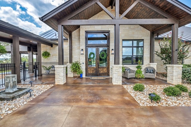 196 Westgate Loop, Horseshoe Bay, TX 78657 - doorway to property with stone siding, french doors, a standing seam roof, and a metal roof