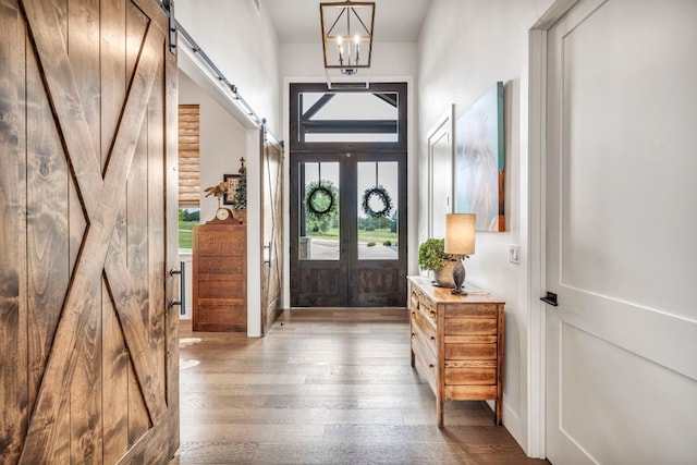 196 Westgate Loop, Horseshoe Bay, TX 78657 - entryway featuring a barn door, wood-type flooring, and french doors