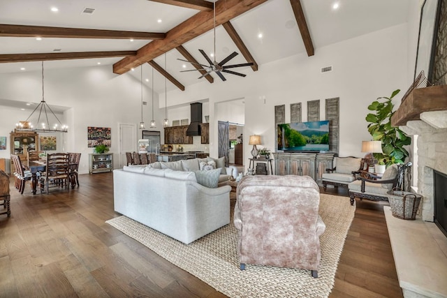 196 Westgate Loop, Horseshoe Bay, TX 78657 - living area with high vaulted ceiling, a chandelier, wood finished floors, a fireplace, and ceiling fan