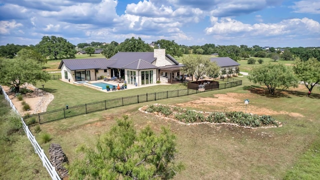 196 Westgate Loop, Horseshoe Bay, TX 78657 - rear view of house with a patio area, a chimney, a fenced backyard, and a metal roof
