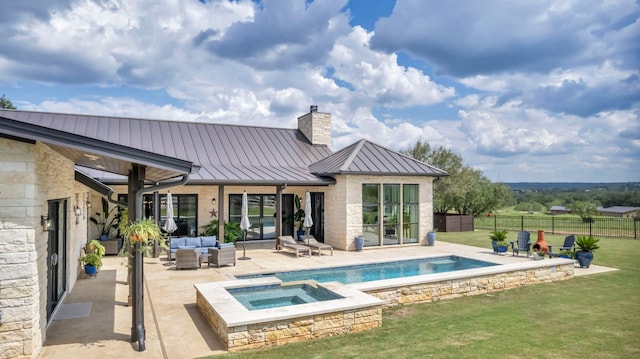 196 Westgate Loop, Horseshoe Bay, TX 78657 - rear view of house featuring a standing seam roof, an outdoor living space, a chimney, a metal roof, and a patio area