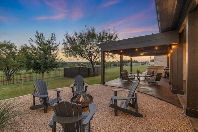 196 Westgate Loop, Horseshoe Bay, TX 78657 - patio terrace at dusk with a fire pit and a patio area