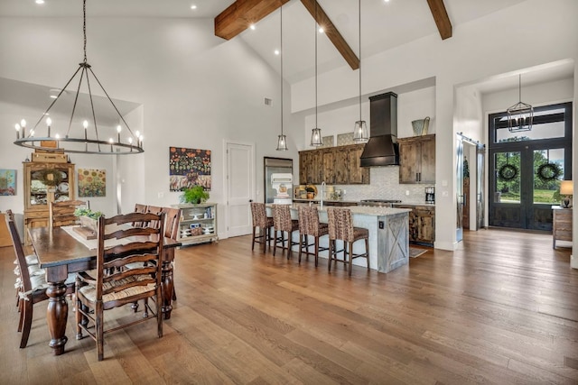 196 Westgate Loop, Horseshoe Bay, TX 78657 - dining room with high vaulted ceiling, beam ceiling, a chandelier, dark wood-style floors, and recessed lighting
