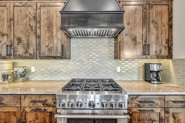 196 Westgate Loop, Horseshoe Bay, TX 78657 - kitchen featuring premium range hood, stainless steel range, decorative backsplash, and light stone countertops