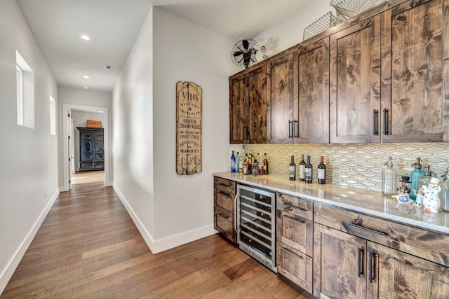 196 Westgate Loop, Horseshoe Bay, TX 78657 - indoor dry bar featuring wine cooler, light wood-style floors, backsplash, and recessed lighting