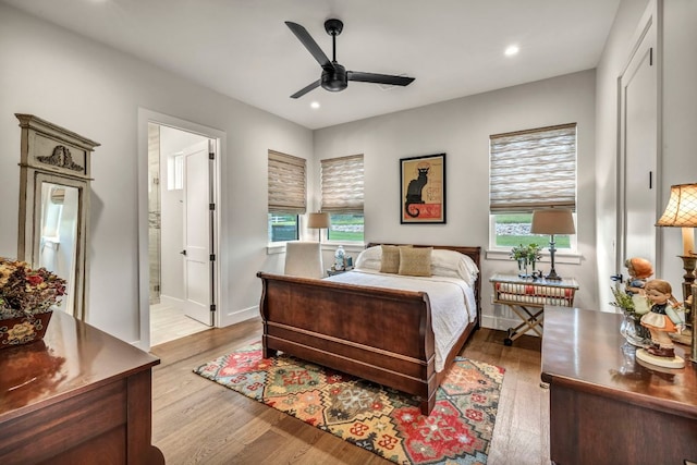 196 Westgate Loop, Horseshoe Bay, TX 78657 - bedroom featuring recessed lighting, light wood-style flooring, connected bathroom, and ceiling fan
