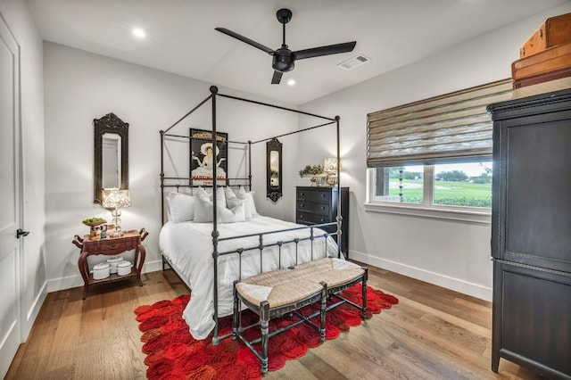 196 Westgate Loop, Horseshoe Bay, TX 78657 - bedroom with wood finished floors, recessed lighting, and ceiling fan