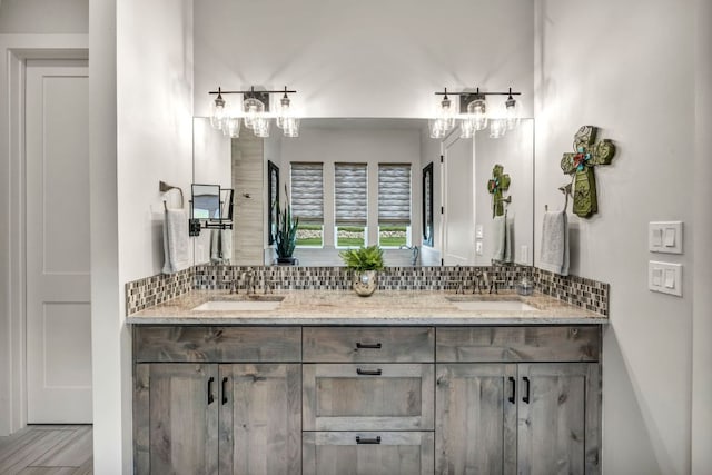 196 Westgate Loop, Horseshoe Bay, TX 78657 - bathroom featuring backsplash, double vanity, and a chandelier