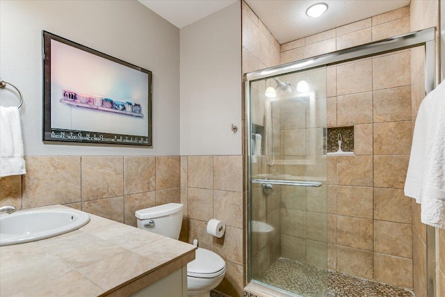 1410 Burford Pl, Austin, TX 78704 - full bathroom with vanity, a shower stall, tile walls, and a wainscoted wall