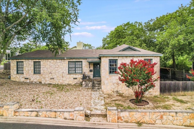 1410 Burford Pl, Austin, TX 78704 - view of front facade featuring stone siding and a chimney
