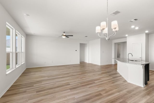 3715 Liberi Ln, Round Rock, TX 78665 - kitchen featuring ceiling fan, light wood-style flooring, a chandelier, recessed lighting, and an island with sink