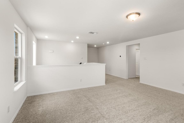 3715 Liberi Ln, Round Rock, TX 78665 - spare room featuring light colored carpet, plenty of natural light, and recessed lighting