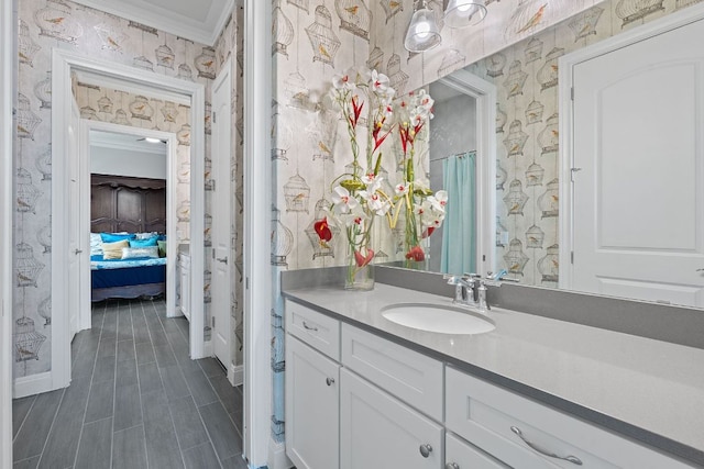 306 Iron Rail Ln, Georgetown, TX 78633 - full bath with wallpapered walls, connected bathroom, vanity, and ornamental molding