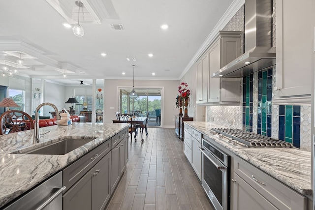 306 Iron Rail Ln, Georgetown, TX 78633 - kitchen featuring wall chimney range hood, stainless steel appliances, ceiling fan, ornamental molding, and tasteful backsplash