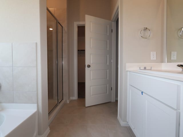 4916 Sea Salt Dr, Austin, TX 78747 - bathroom with a stall shower, vanity, tile patterned flooring, and a bath