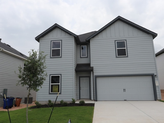 4916 Sea Salt Dr, Austin, TX 78747 - view of front facade with board and batten siding, concrete driveway, an attached garage, and a front yard
