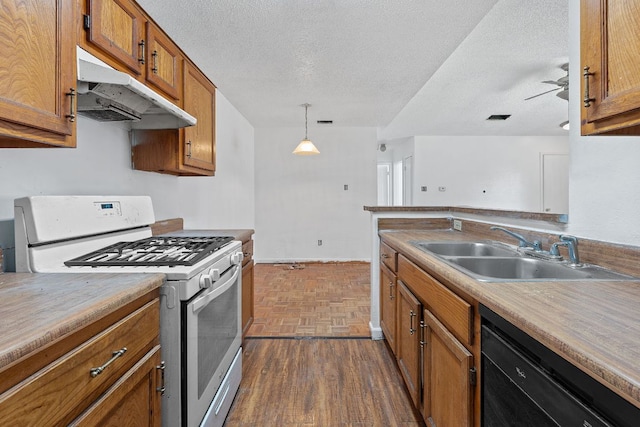 12323 Alderbrook Dr, Austin, TX 78758 - kitchen with white gas stove, under cabinet range hood, black dishwasher, brown cabinets, and a textured ceiling