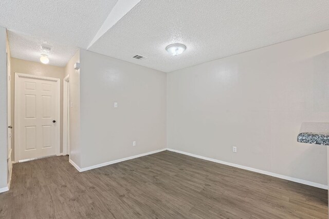12323 Alderbrook Dr, Austin, TX 78758 - empty room with wood finished floors and a textured ceiling