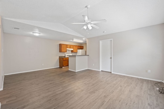 12323 Alderbrook Dr, Austin, TX 78758 - unfurnished living room featuring a ceiling fan, wood finished floors, and lofted ceiling