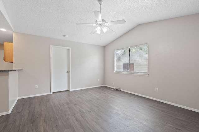 12323 Alderbrook Dr, Austin, TX 78758 - spare room with a ceiling fan, a textured ceiling, dark wood-style flooring, and lofted ceiling