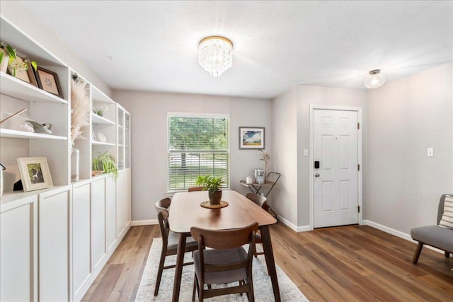 161 Buttercup Way, Kyle, TX 78640 - dining area with light wood-style flooring and a chandelier