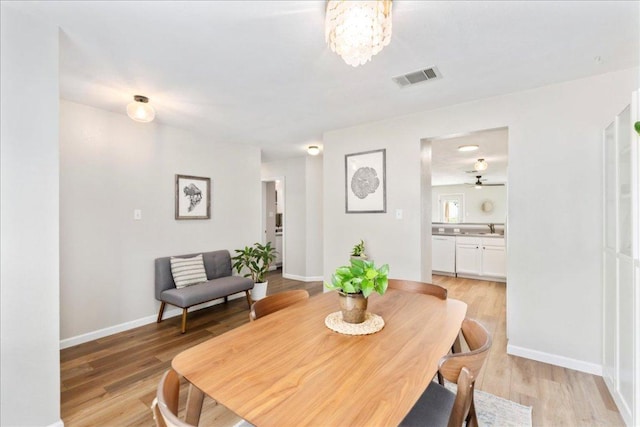 161 Buttercup Way, Kyle, TX 78640 - dining room with light wood-style flooring and a chandelier